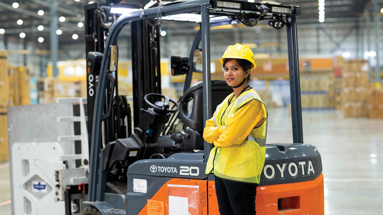 Indian forklift operator working in warehouse, handling logistics operations